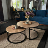 Round nesting table set of two with a wooden top and black metal frame, perfect for living room decor